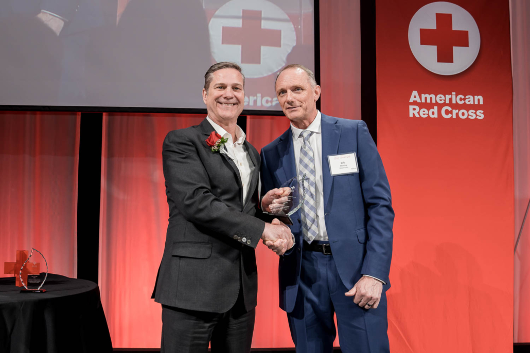 An image of Chris Kolenda accepting the military award for last fall’s 1700-mile Fallen Hero Honor Ride at the the Wisconsin Red Cross Brave Hearts award gala.